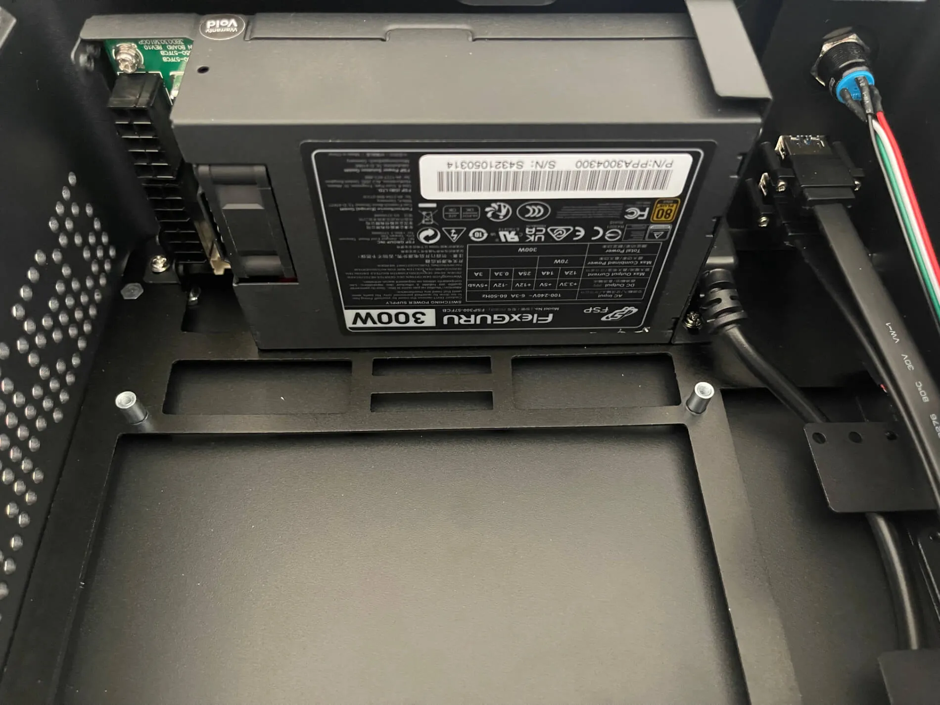 FSP Flexguru 300W power supply mounted at the top of the case, above the empty board tray